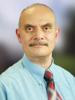 founder A man with a mustache and a blue shirt
