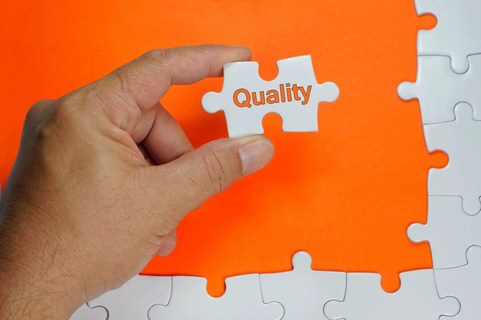 fm=f_4706 A person holding a puzzle piece that says quality.